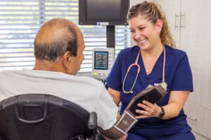 Nurse taking resident's blood pressure